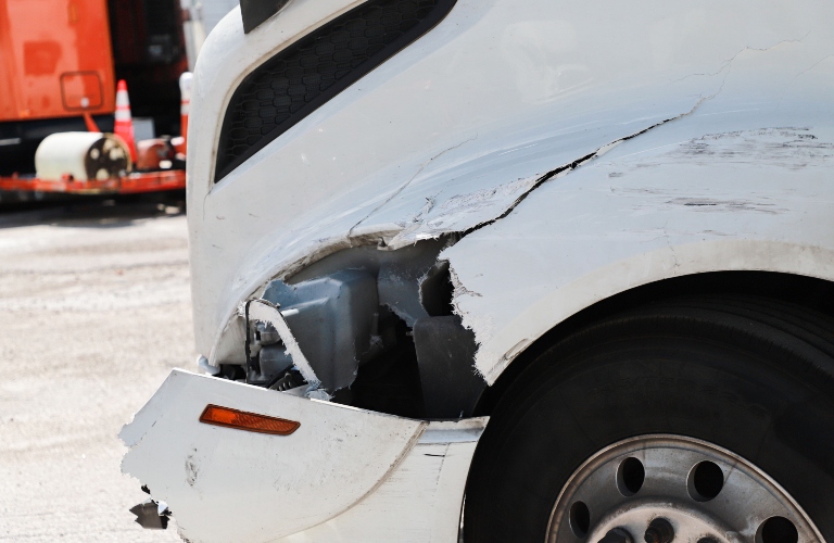 Damage closeup on white semi truck