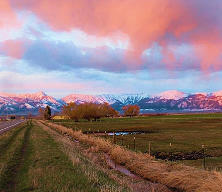 a road with mountains in the background