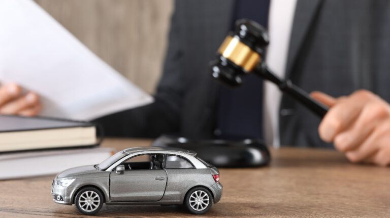 Man with document and gavel at wooden table